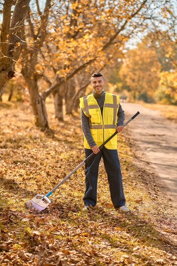 man yellow vest raking leaves park 259150 57324