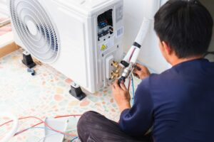 Engineer installing modern HVAC system as part of ESG carbon arbitrage facilities management project